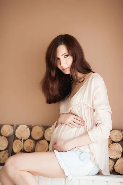Glückliche Junge Schwangere Frau Auf Pastellfarbenem Hintergrund Mit Holzelementen — Stockfoto