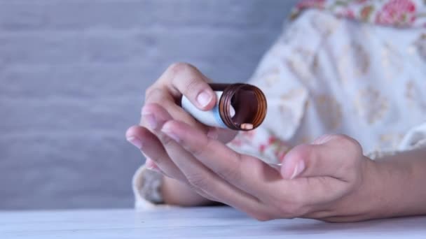 Femmes prendre des médicaments à la main du récipient pilule — Video