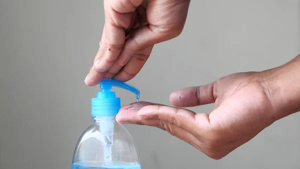 Close up of person hand using sanitizer for preventing virus,