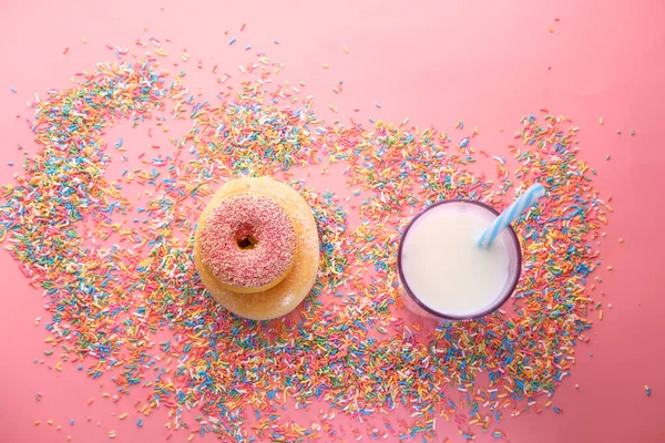 Top view of donuts and milk on white .