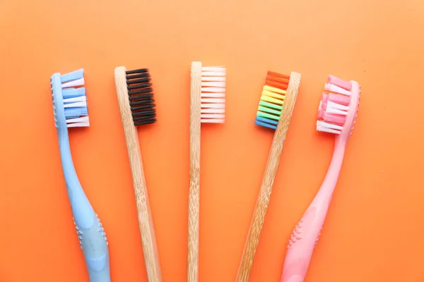 Close up of colorful tooth brush on orange background. — Stock Photo, Image