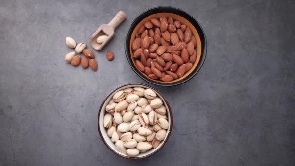 High angle view of almond and pistachios nut on gray background — Stock Video