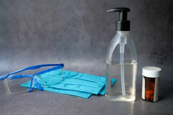 face mask, sanitizer on wooden table with copy space