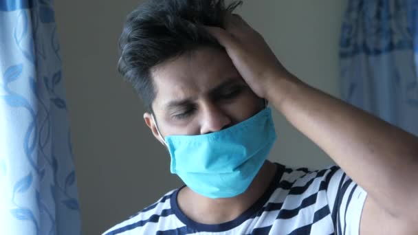 A young asian man mask on his face suffering headache — Stockvideo