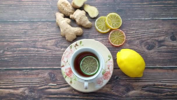 Top view of ginger tea on wooden background. — Stock Video