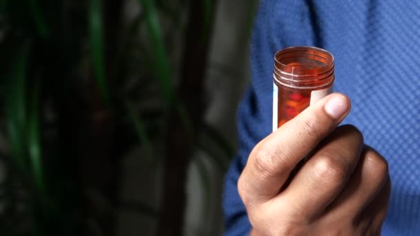 Close up of man hand holding pill container indoor — Stock video