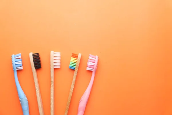 Primer plano de cepillo de dientes de colores sobre fondo naranja . — Foto de Stock