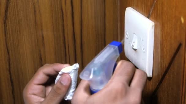 Close up of person hand wiping light switch. — Stock Video