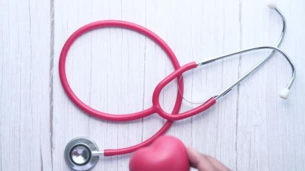 Heart shape symbol and stethoscope on white background — Stock Video