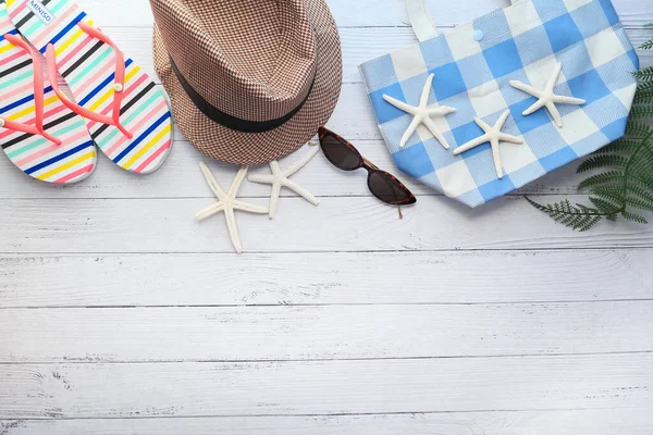 Flat lay composition of outfit of traveler on wooden desk. — Stock Photo, Image