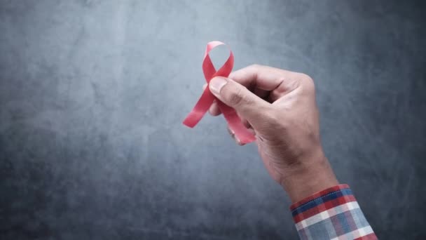 Férfi kezében piros HIV szalag másolási hely — Stock videók