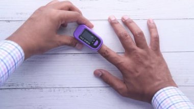  Oksijen doygunluğunu ölçmek için nabız oksimetresi olan insan parmağı