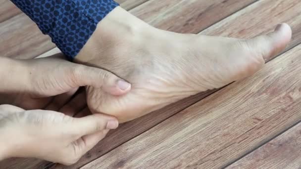 Frau berührt Fuß unter Schmerzen aus nächster Nähe. — Stockvideo