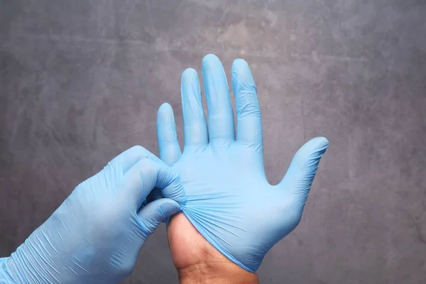 man doctor wears medical gloves, close up