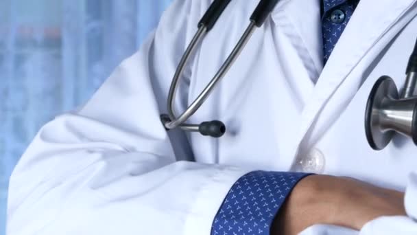 Close up of doctor with arms crossed and stethoscope on neck , — Stock Video