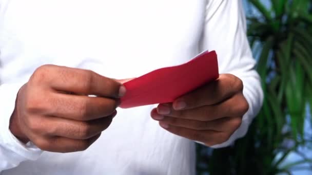 Close up of man hand holding red envelope. — Stock Video