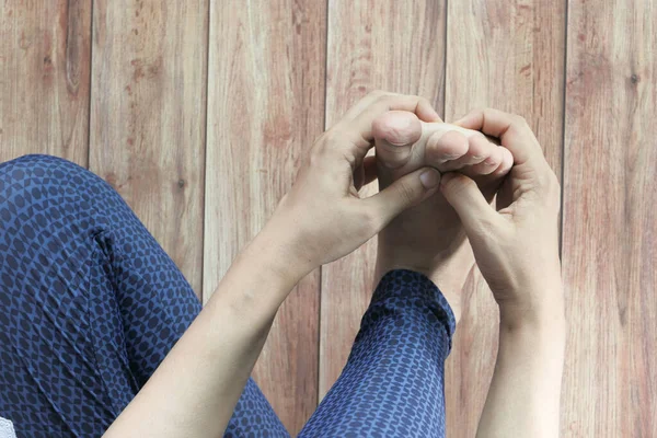 Nahaufnahme an den Füßen der Frauen und Handmassage an der Verletzungsstelle. — Stockfoto