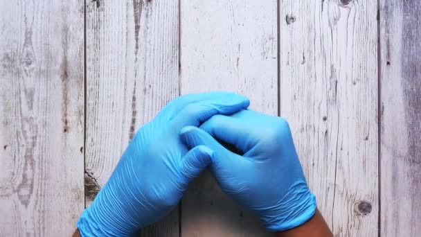 Doktor hand med handske på trä bakgrund. — Stockvideo