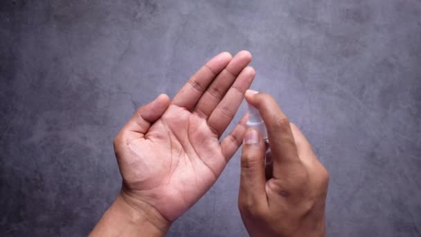 Gros plan de la main du jeune homme à l'aide de spray désinfectant pour les mains. — Video