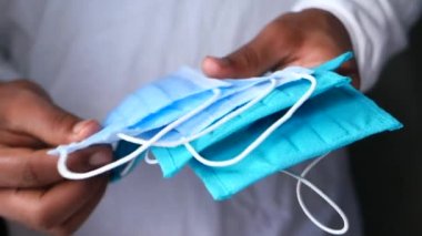  Adam elinde cerrahi maske tutuyor, yakın plan. 