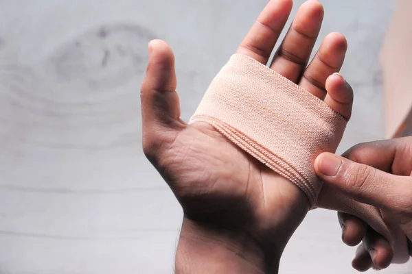 Close up of man hand with bandage — Stock Photo, Image
