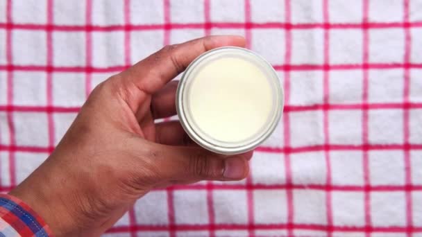 Bovenaanzicht van de mens hand eten verse yoghurt uit een kom — Stockvideo