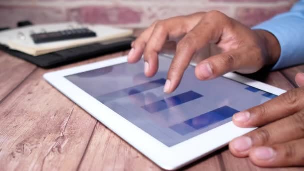 Close-up van zakenmensen hand analyseren staafdiagram op digitale tablet — Stockvideo
