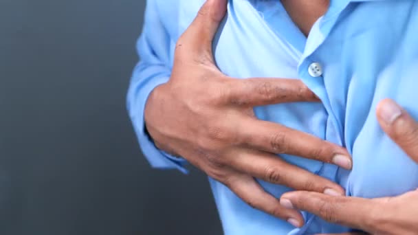 Jonge man lijden hart en houden van zijn borst. — Stockvideo