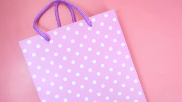 Women gift bag on pink background top view. — Stock Video
