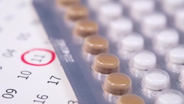 Birth control pills , calendar and notepad on table — Stock Video