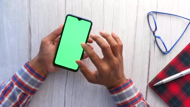 Pohled shora na člověka rukou pomocí chytrého telefonu na kancelářském stole — Stock video