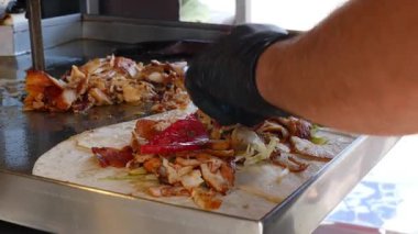 Yetenekli eller bir shawarma sargısı hazırlayın.