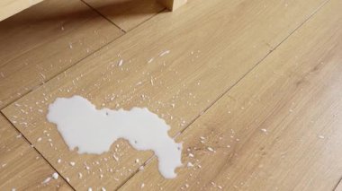 Süt, ahşap bir zemine döküldü ve arkasında temizlenecek önemli bir pislik bıraktı..