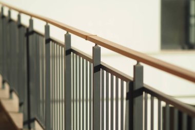 Railing contrasts with light walls in a bright and modern space.
