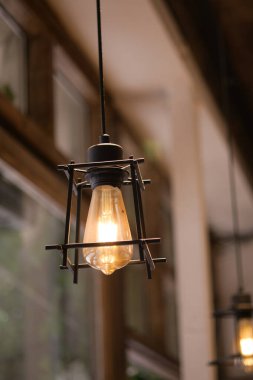 Vintage light fixture illuminates a warm cafe environment with charm.