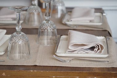 Cam ve keten peçeteli güzel bir yemek masası..
