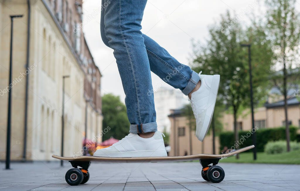 Man riding on a skateboard on urban street. Active lifestyle concept 