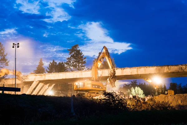 Olsany Çek Cumhuriyeti 16 Haziran 2018 Karayolu Köprüsü yıkım gece sahne. Hightway imar sitesi reflektör, ışıklar. Ağır Ekskavatör ve kazma bir beton köprü yıkmak.