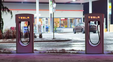 Olomouc Çek Cumhuriyeti 16th Ocak 2018 - Tesla hızlı şarj gece arka planda bir benzin istasyonu ile detay. Elektrik vs geleneksel motoru.