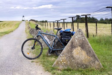 Cizov Czech Rep 23th June 2018 Eurovelo 13, bicycle with bags standing by the rest of the Iron Curtain at Czech - Austrian borders, south Moravia. The Iron Curtain Trail. clipart