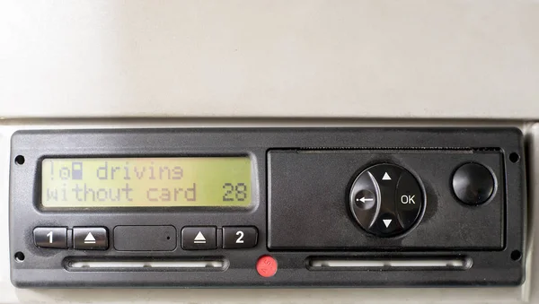 Digital tachograph display reads DRIVING WITHOUT CARD. No inserted card in the device. Insert the drivers card. No personal data