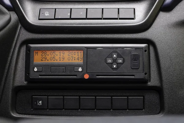 Digital tachograph display shows time difference after driver inserts the card into the device when starting shift. No personal data. Tachograph in a van — Stock Photo, Image