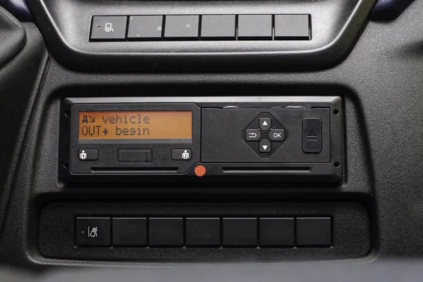 Digital tachograph display reads Vehicle Out Begin. No personal data. Tachograph in a van — Stock Photo, Image
