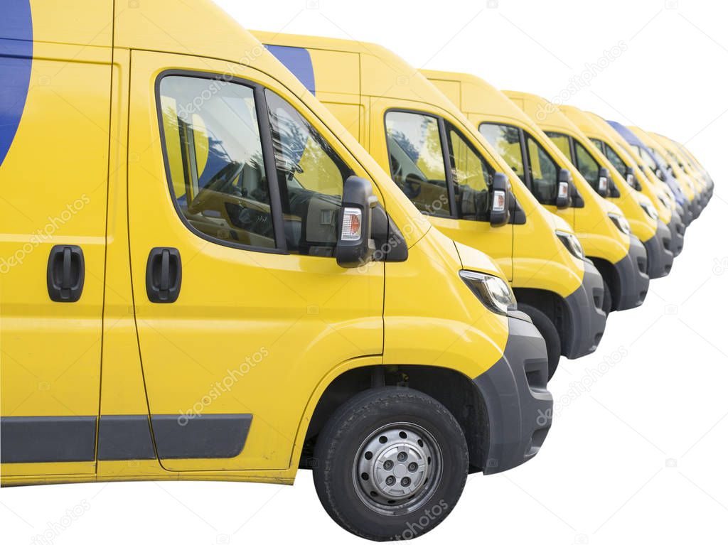 Yellow vans lined up and parked in a long row isolated on white background. Delivery trucks fleet