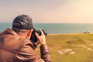 Nature photographer by the sea clipart