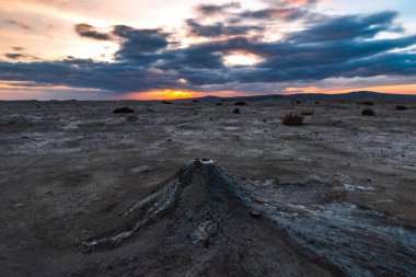 Mud volcanoes at sunset,  amazing natural phenomenon clipart