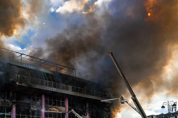 Burning building in thick toxic smoke