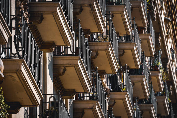 Low angle view of rows of neoclassical balconies on the facade of a residential building