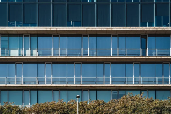 Minimalist architecture of the glass and concrete facade of an urban building