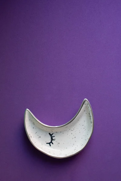 moon shaped plate on purple background